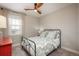 Bright bedroom featuring a soft color palette, window, and wooden fan at 8010 Blue River Ave, Littleton, CO 80125