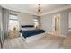 Stylish bedroom featuring neutral colors, a modern chandelier, and large windows for ample natural light at 8010 Blue River Ave, Littleton, CO 80125