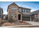 Charming two-story home with a stone facade and well-maintained landscaping at 8010 Blue River Ave, Littleton, CO 80125