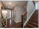 Elegant foyer with hardwood floors, staircase, and neutral paint at 8010 Blue River Ave, Littleton, CO 80125