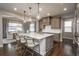 Bright kitchen with large island, pendant lighting, and stainless steel appliances at 8010 Blue River Ave, Littleton, CO 80125