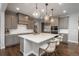 Beautiful kitchen with grey cabinets, a large island, quartz countertops, and stainless steel appliances at 8010 Blue River Ave, Littleton, CO 80125