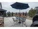 Back patio with a table, chairs, and a grill covered by a patio umbrella at 8010 Blue River Ave, Littleton, CO 80125