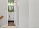 Hallway peek into a renovated bathroom with granite counters and modern vanity at 12814 Jasmine St # C, Thornton, CO 80602