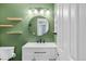 Beautiful bathroom with updated lighting, floating shelves, and a large mirror at 12814 Jasmine St # C, Thornton, CO 80602