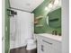 Stylish bathroom boasts modern fixtures, sleek vanity, and floating wood shelves at 12814 Jasmine St # C, Thornton, CO 80602