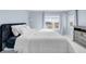 Well-lit bedroom featuring a cozy bed and bright windows at 12814 Jasmine St # C, Thornton, CO 80602