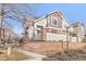 Side exterior view of townhome showing architectural detail and brick retaining wall at 12814 Jasmine St # C, Thornton, CO 80602