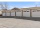 Detached garages with white doors and stone accents lining the street, providing ample parking at 12814 Jasmine St # C, Thornton, CO 80602