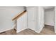 Hallway with staircase, wood banister, and multiple entryways at 12814 Jasmine St # C, Thornton, CO 80602