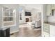 Bright living room featuring a fireplace, large windows, and light wood floors at 12814 Jasmine St # C, Thornton, CO 80602