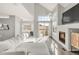 Bright living room featuring sliding glass doors, fireplace, and hardwood floors at 12814 Jasmine St # C, Thornton, CO 80602