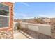 Private patio with brick and wood accent, offering a view of townhome exteriors and a blue sky at 12814 Jasmine St # C, Thornton, CO 80602