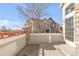 Private patio area showing the exterior of the building and a glimpse of the surrounding neighborhood at 12814 Jasmine St # C, Thornton, CO 80602