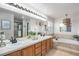 Well-lit bathroom with double vanity, soaking tub, and walk-in shower at 13340 Saint Paul St, Thornton, CO 80241