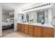 Bathroom boasts dual sinks, vanity with cabinets, and is connected to the bedroom, providing ample space at 13340 Saint Paul St, Thornton, CO 80241