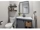 Contemporary bathroom with a sleek vanity, stylish mirror, modern toilet, and elegant fixtures for a touch of luxury at 13340 Saint Paul St, Thornton, CO 80241