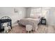 Charming bedroom features a cozy bed, soft textures, and a window that fills the space with natural light at 13340 Saint Paul St, Thornton, CO 80241