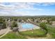 Aerial view of a community pool with lush landscaping and seating areas, perfect for summer relaxation at 13340 Saint Paul St, Thornton, CO 80241