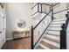 Beautiful entryway featuring a staircase with black accents and wood flooring at 13340 Saint Paul St, Thornton, CO 80241