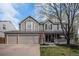 Charming two-story home with a large front yard, covered porch, and three-car garage at 13340 Saint Paul St, Thornton, CO 80241