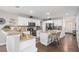 Bright kitchen features white cabinets, granite countertops, stainless appliances and an island with seating at 13340 Saint Paul St, Thornton, CO 80241
