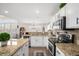 Open kitchen features granite counters, stainless steel appliances and seamlessly connects to the adjacent living area at 13340 Saint Paul St, Thornton, CO 80241