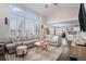 Open living room with vaulted ceilings, large windows and hardwood floors throughout at 13340 Saint Paul St, Thornton, CO 80241