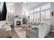 Bright living room features a fireplace, tall windows, and comfortable seating, creating a welcoming atmosphere at 13340 Saint Paul St, Thornton, CO 80241