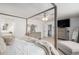 Bright main bedroom with four-poster bed and ensuite bath with tub at 13340 Saint Paul St, Thornton, CO 80241