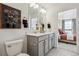 Bathroom with double vanity and access to bedroom at 948 Andrews Crest Dr, Berthoud, CO 80513
