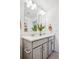 Shared bathroom with double vanity and gray cabinets at 948 Andrews Crest Dr, Berthoud, CO 80513