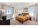 Bright bedroom with double windows and orange bed at 948 Andrews Crest Dr, Berthoud, CO 80513