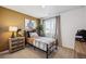 Cozy bedroom with a twin bed, dresser, and window at 948 Andrews Crest Dr, Berthoud, CO 80513
