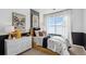 Bright bedroom with a full bed, dresser, and large window at 948 Andrews Crest Dr, Berthoud, CO 80513