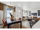 Open concept dining room with contemporary chandelier at 948 Andrews Crest Dr, Berthoud, CO 80513