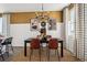 Dining room with a dark wood table and mustard-colored chairs at 948 Andrews Crest Dr, Berthoud, CO 80513