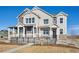 Two-story home with gray and beige siding, a black fence, and a landscaped yard at 948 Andrews Crest Dr, Berthoud, CO 80513