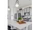 Modern kitchen island with white quartz countertops at 948 Andrews Crest Dr, Berthoud, CO 80513