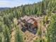Majestic aerial view of a home in the evergreen mountains, revealing multiple decks at 33121 Lynx Ln, Evergreen, CO 80439