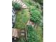 Aerial view of a backyard with a green lawn, landscaping, and stone steps at 33121 Lynx Ln, Evergreen, CO 80439