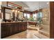 Bright bathroom with double vanity, soaking tub by the window, and a glass enclosed shower at 33121 Lynx Ln, Evergreen, CO 80439