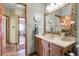 Well-lit bathroom with decorative mirror, modern sink, and wood cabinets at 33121 Lynx Ln, Evergreen, CO 80439