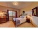 Cozy bedroom with decorative metal bed frame, dresser, and exterior view at 33121 Lynx Ln, Evergreen, CO 80439