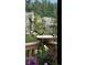 A bird feeder with birds on a deck with flowers and a view of trees and a rock face at 33121 Lynx Ln, Evergreen, CO 80439