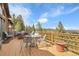 Beautiful outdoor deck with mountain views and comfortable seating and dining area at 33121 Lynx Ln, Evergreen, CO 80439