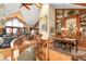 Elegant dining area featuring built-in wooden shelving, a dining table, and plenty of natural light from the large windows at 33121 Lynx Ln, Evergreen, CO 80439
