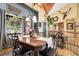 Charming dining room with wood table, chandelier, and bright, sunny windows at 33121 Lynx Ln, Evergreen, CO 80439