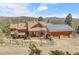 Stunning exterior showcasing a log cabin-style home with solar panels and mountain views at 33121 Lynx Ln, Evergreen, CO 80439