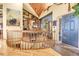 Inviting home foyer featuring a curved staircase, built-in bookshelves, and natural light at 33121 Lynx Ln, Evergreen, CO 80439
